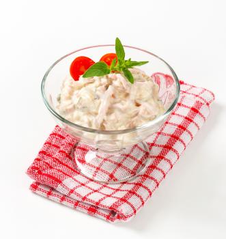 Ham and potato salad in a glass serving bowl