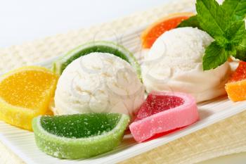 Scoops of white ice cream garnished with jelly candy