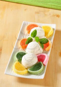 Scoops of white ice cream garnished with jelly candy