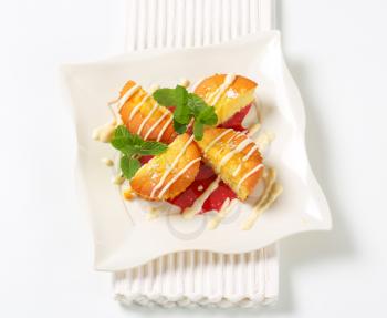 Custard filled muffins with raspberry sauce