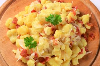 Small potato dumplings with bacon and white cabbage