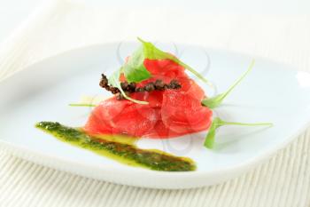 Thin slices of raw beef with pesto