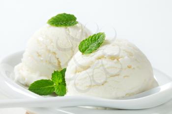 Two scoops of white ice cream (lemon, yogurt or mint flavor)
