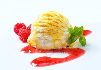 Scoop of ice cream decorated with raspberry sauce