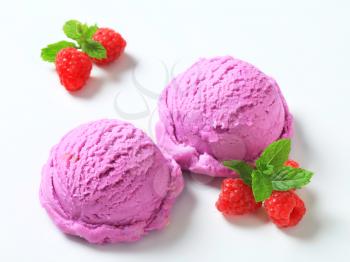 Scoops of purple ice cream and fresh raspberries