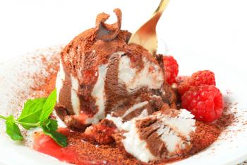 Vanilla chocolate ice cream with raspberries sprinkled with cocoa powder