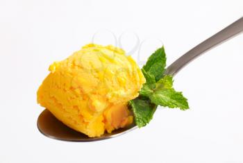 Yellow ice cream on a spoon