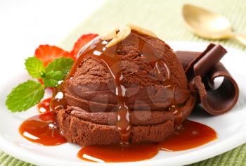 Scoop of chocolate ice cream with caramel syrup
