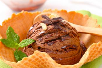 Scoop of chocolate fudge ice cream in a waffle basket