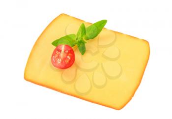 Slice of smoked cheese on white background