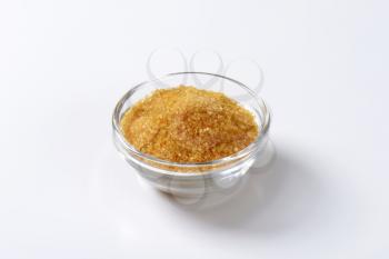 Bowl of golden brown raw cane sugar