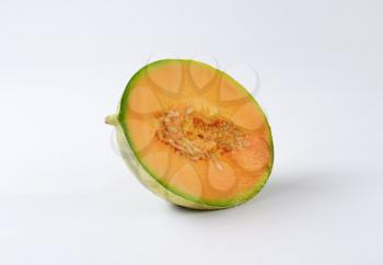 Half a cantaloupe melon on white background