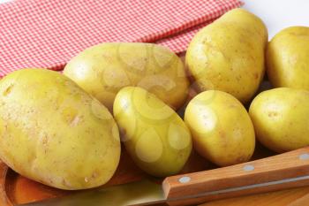 Unpeeled new potatoes on cutting board