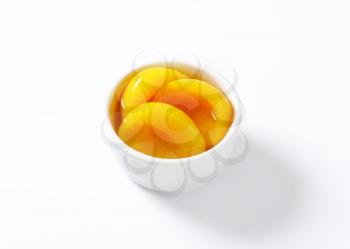 Bowl of peach halves in light syrup