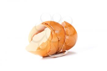 Empty brown egg shells on white background
