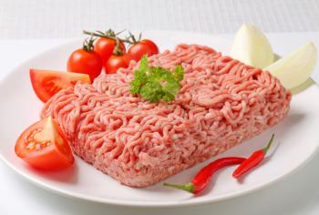 Raw ground pork and vegetables on plate