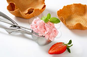Scoop of pink ice cream and waffle baskets - still life
