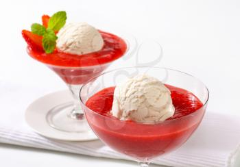 Ice cream with strawberry puree in stemmed glasses