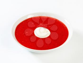 Bowl of chilled strawberry soup with cream