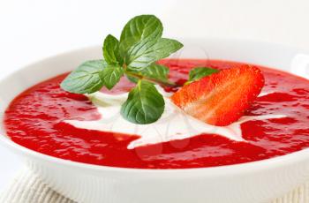 Bowl of chilled strawberry soup with cream