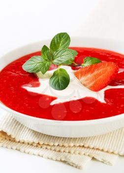 Bowl of chilled strawberry soup with cream