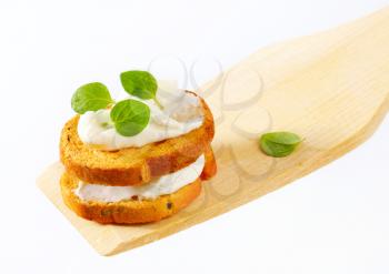 Small round toasts with cheese spread
