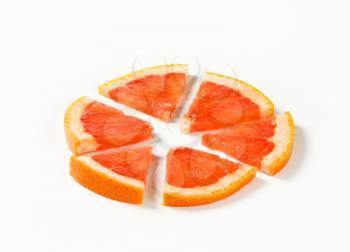 Slice of red grapefruit cut into sixths