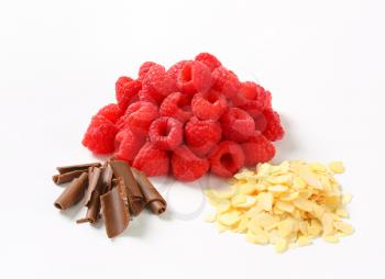 Heaps of fresh raspberries, chocolate curls and sliced almonds