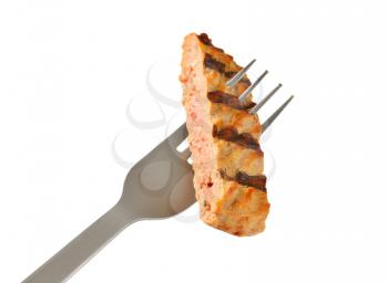 Strip of grilled burger on a fork