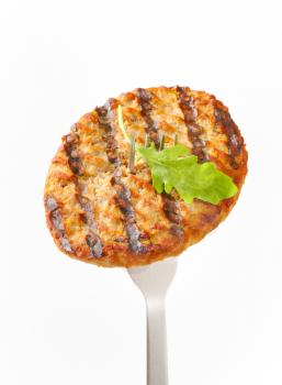 Grilled patty on a fork