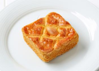 Small square cake filled with thick almond paste