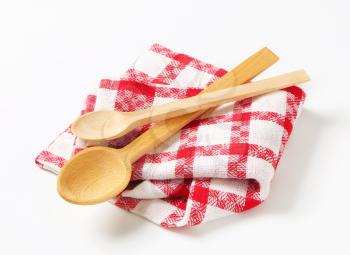 Red and white tea towel and wooden spoons