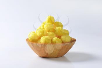 Puffed snack - Cereal balls in wooden bowl