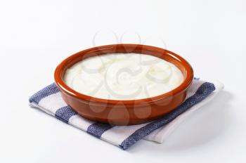 Smooth semolina porridge served in terracotta dish