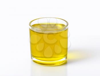 Glass of extra virgin olive oil