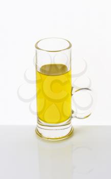Olive oil in tall glass mug