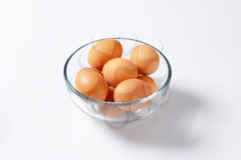 Brown organic eggs in a glass bowl