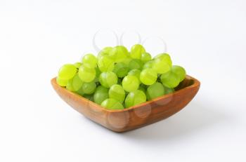 Fresh white grapes in square wooden bowl