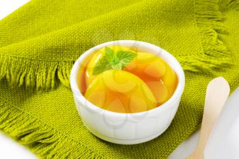 Bowl of peach halves in light syrup