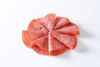 Thinly sliced salami infused with pieces of black truffles