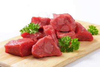 Raw diced beef on cutting board