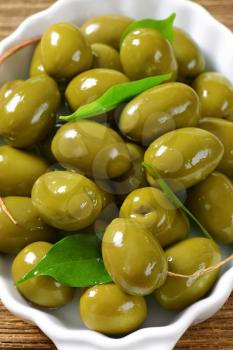 Fresh green olives in ceramic dish
