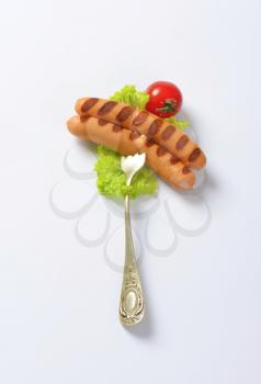 Grilled Vienna sausages on vintage fork