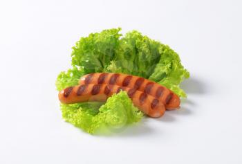Grilled Mini Vienna sausages on lettuce leaves