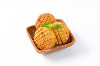 Small savory biscuits in square wooden bowl