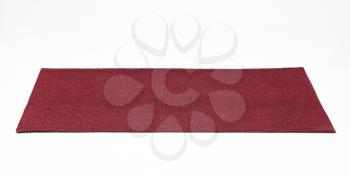 Rectangular burgundy place mat on white background