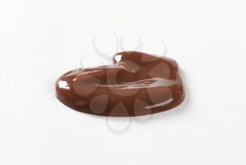 blob of chocolate pudding on white background