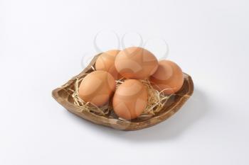bowl of fresh eggs on white background