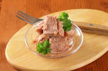 bowl of tuna salad on wooden cutting board