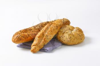 assorted bread rolls on blue napkin